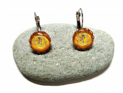 Boucles d'oreilles en dormeuse avec le 2ème chakra pour retrouver l'équilibre entre passion et sérénité intérieure.